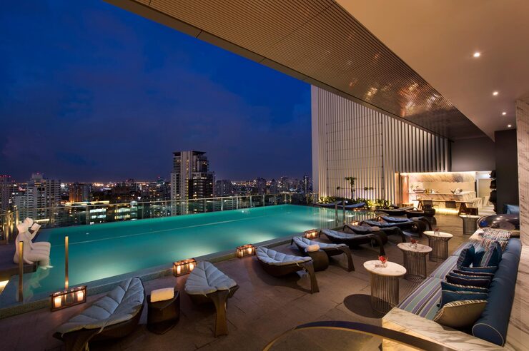 Rooftop swimming pool at dusk with loungers, illustrating community amenities at Serene Sagara