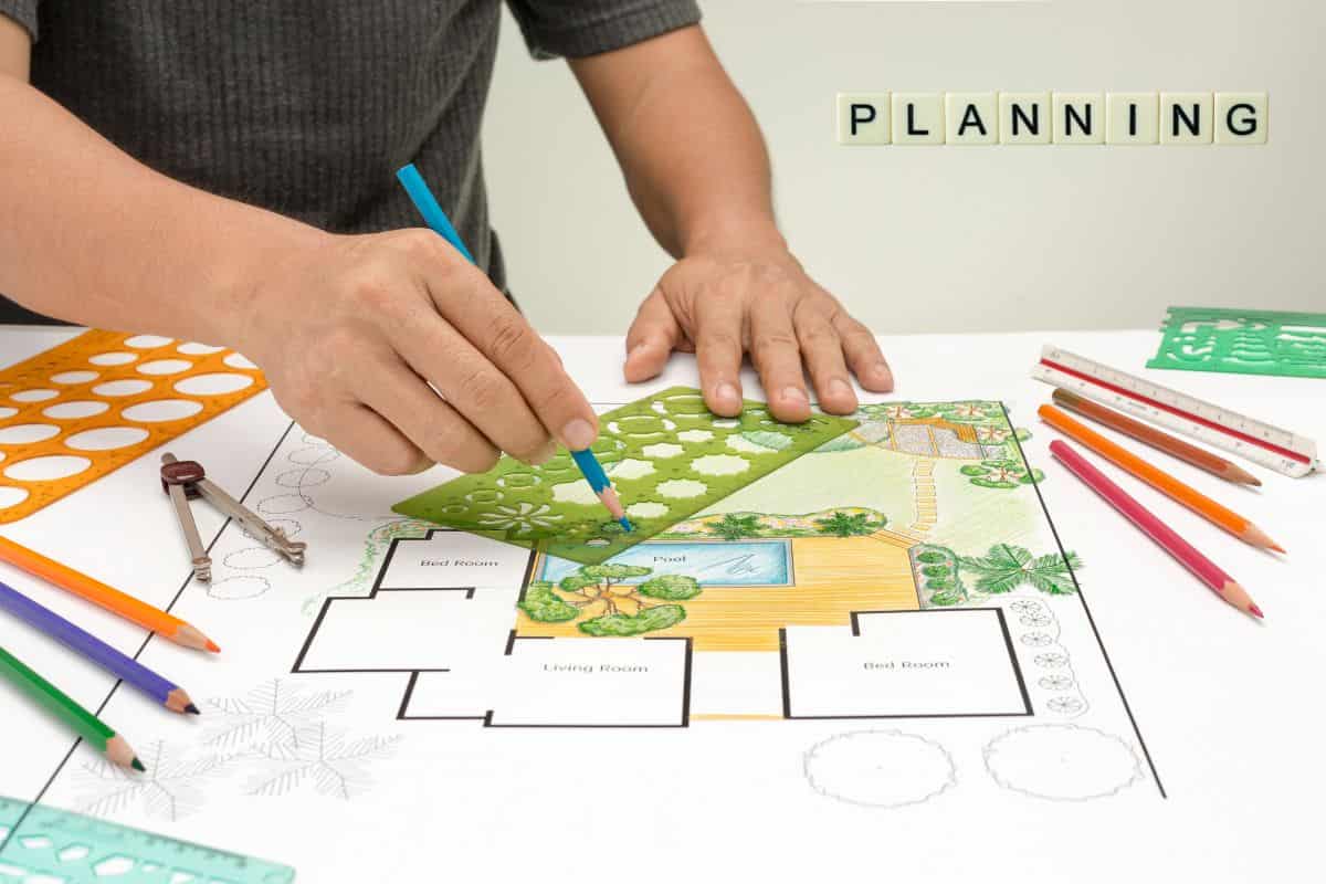 Designer sketching a site layout on a planning sheet, illustrating the master plan of Serene Sagara